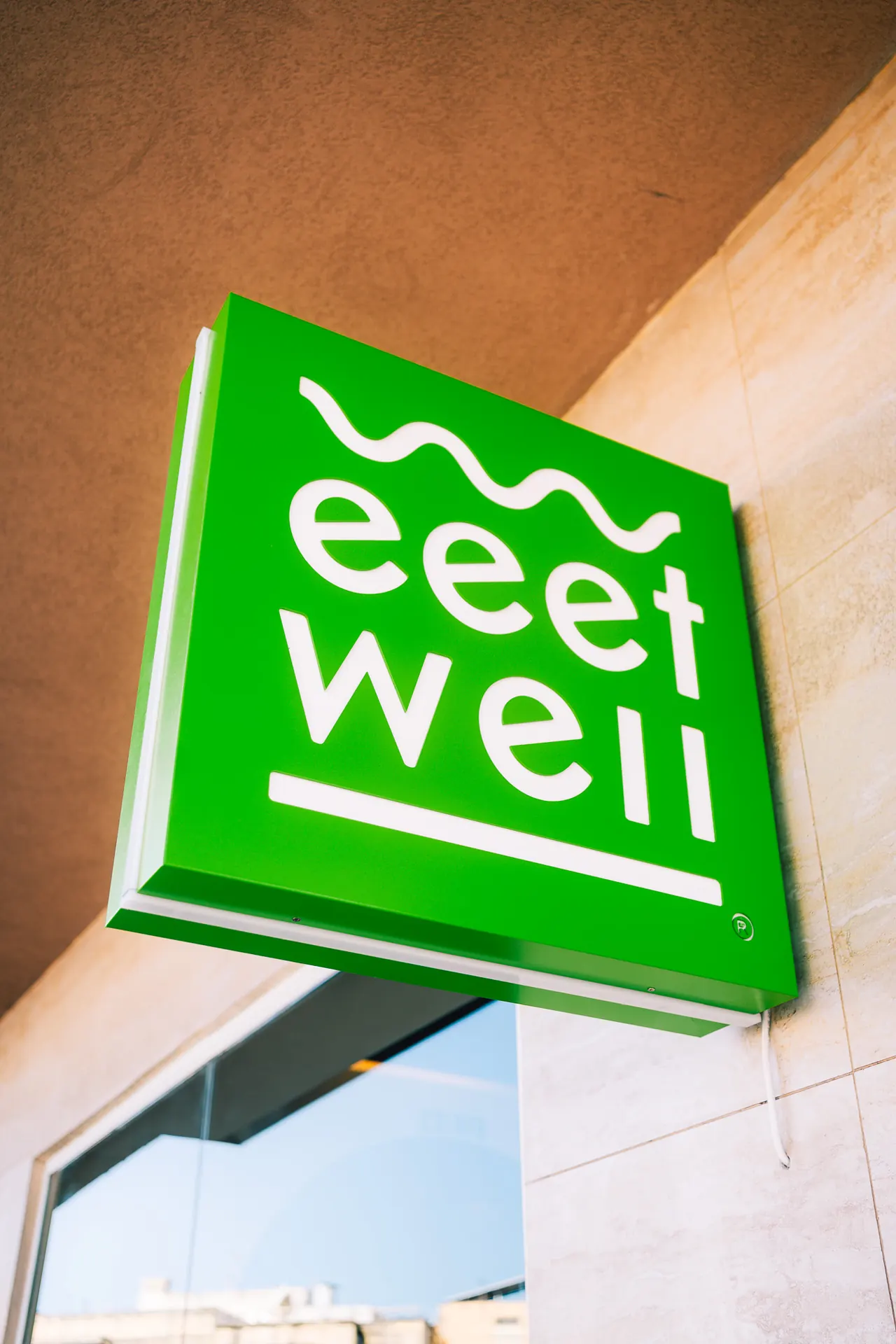 eeetwell projecting sign on the building
